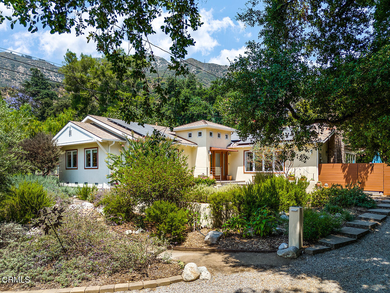 a front view of a house with a yard and tree s