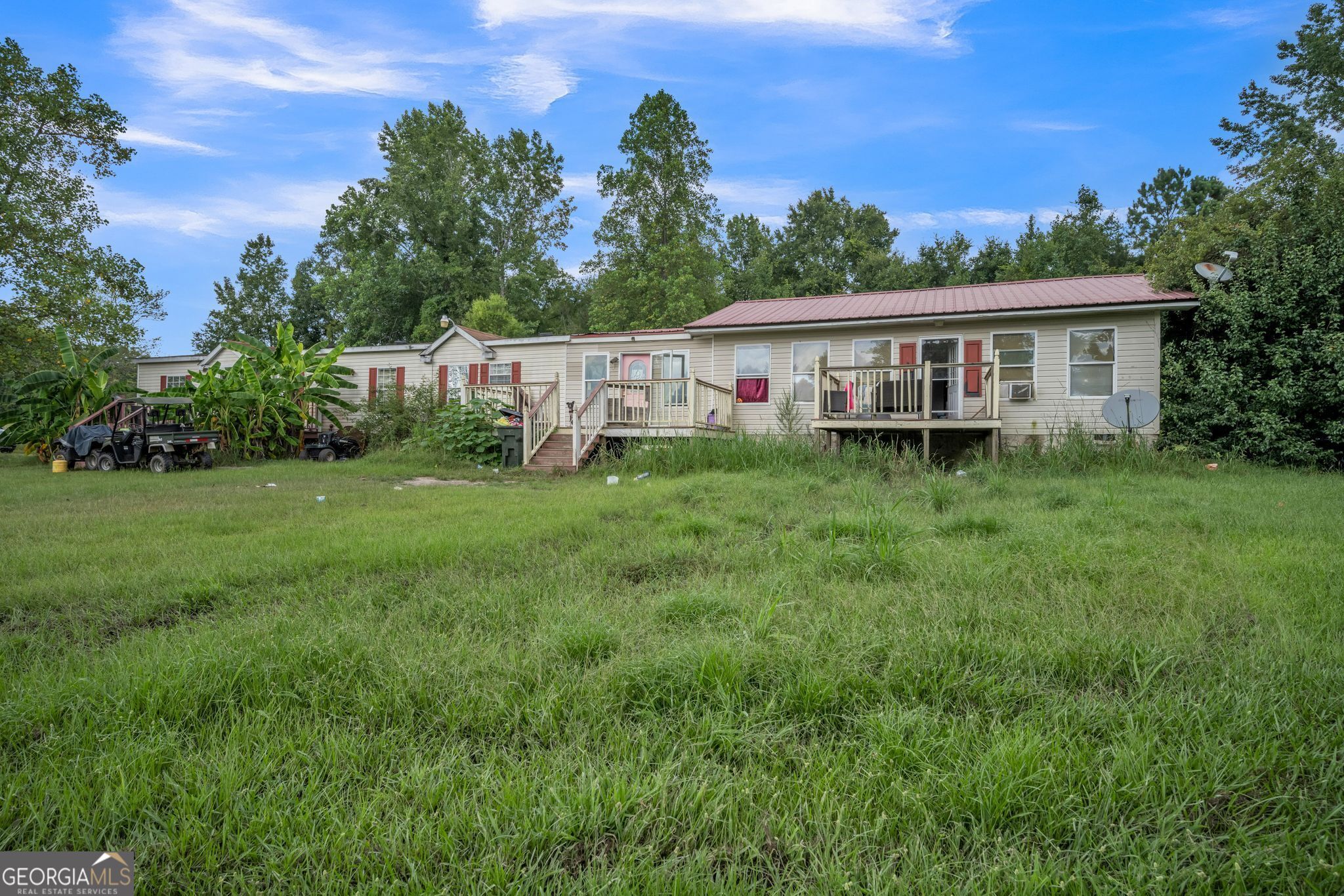 a view of a house with a yard and sitting area