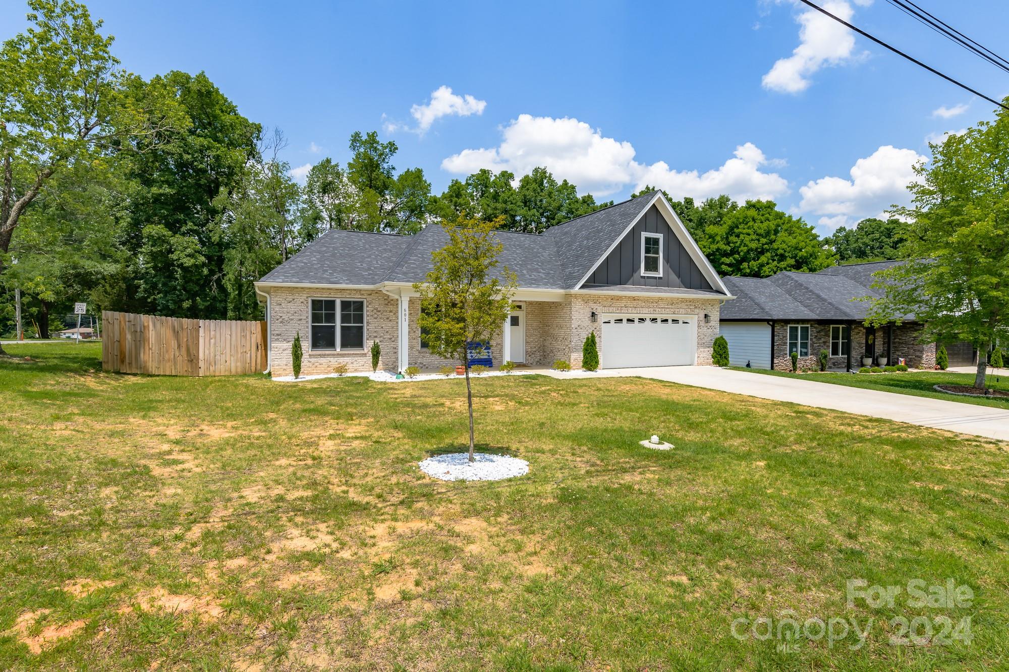 a front view of house with yard and green space