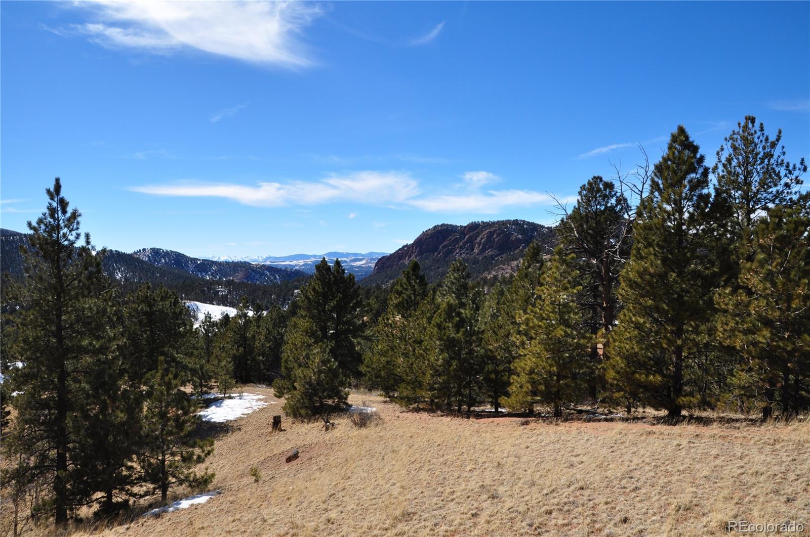 a view of a snow covered with snow in the background