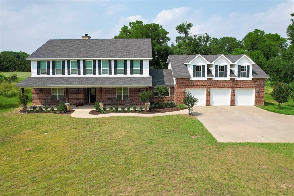 a front view of a house with swimming pool having outdoor seating