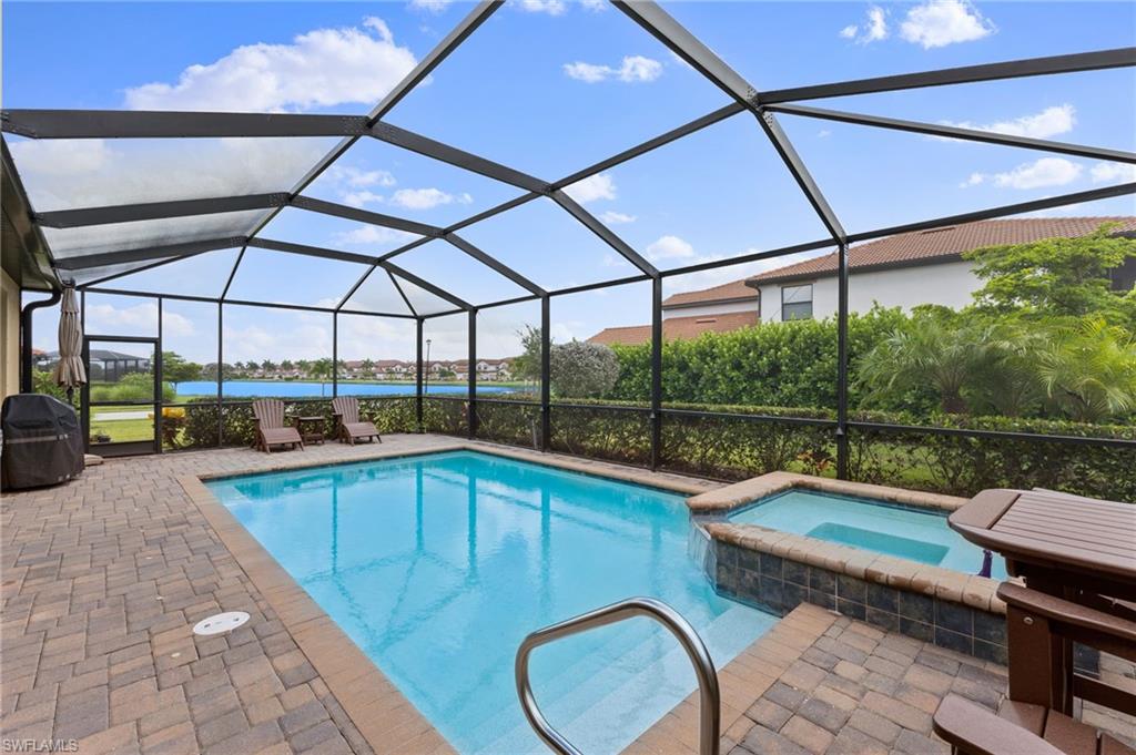 Pool with an in ground hot tub, lake views and no seeum screened lanai