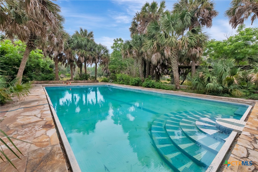 a view of a swimming pool with a patio