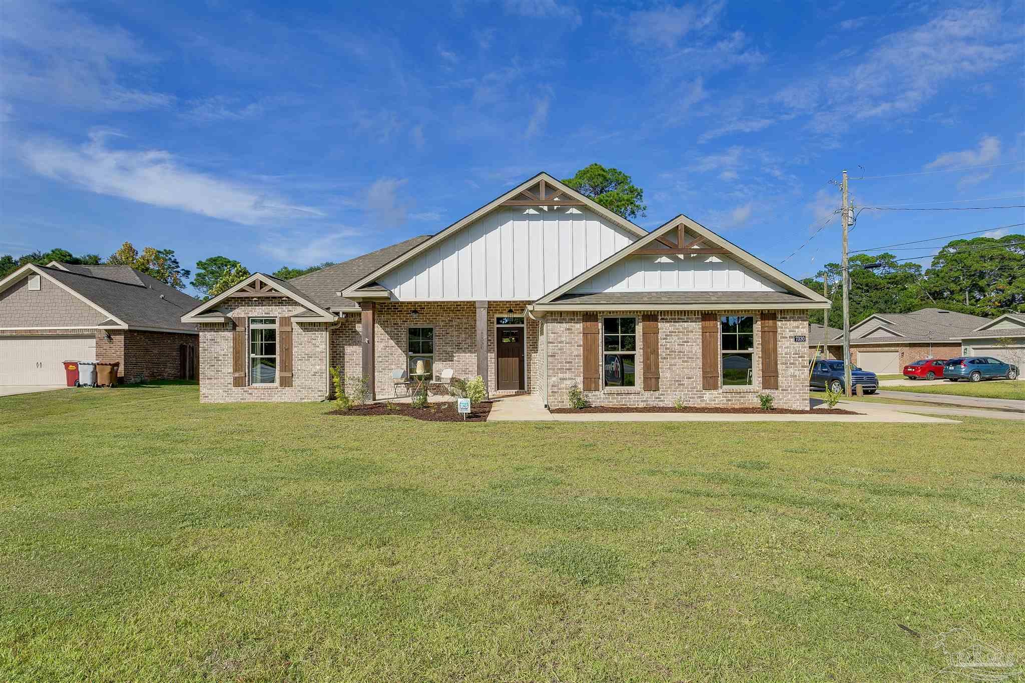 a front view of a house with a garden and porch