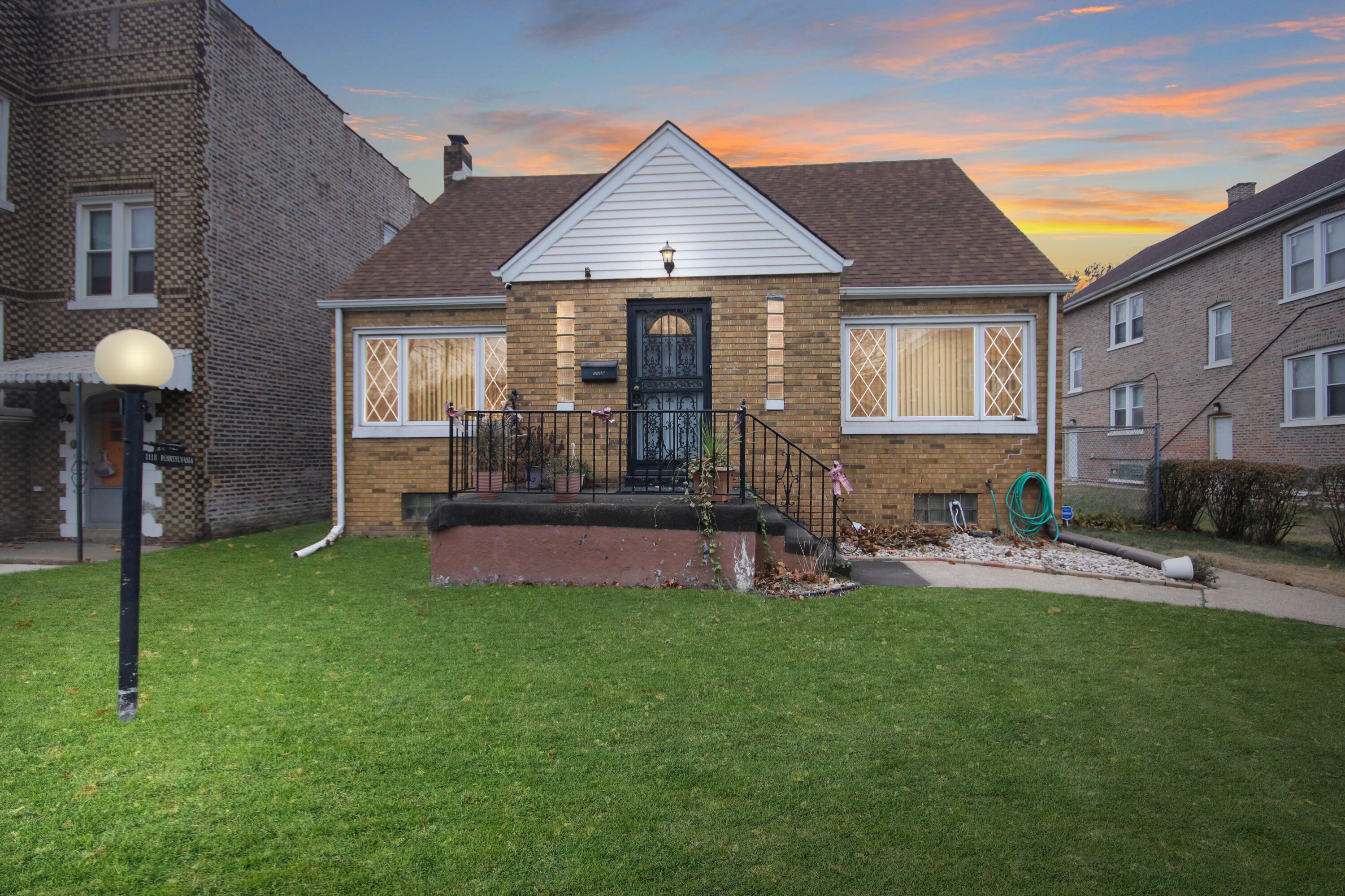 a front view of a house with a yard and patio