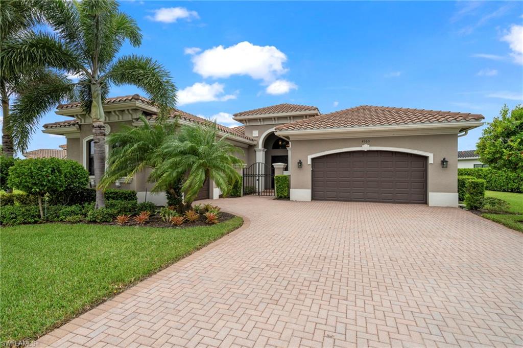 Mediterranean / spanish-style house featuring a front lawn and a garage