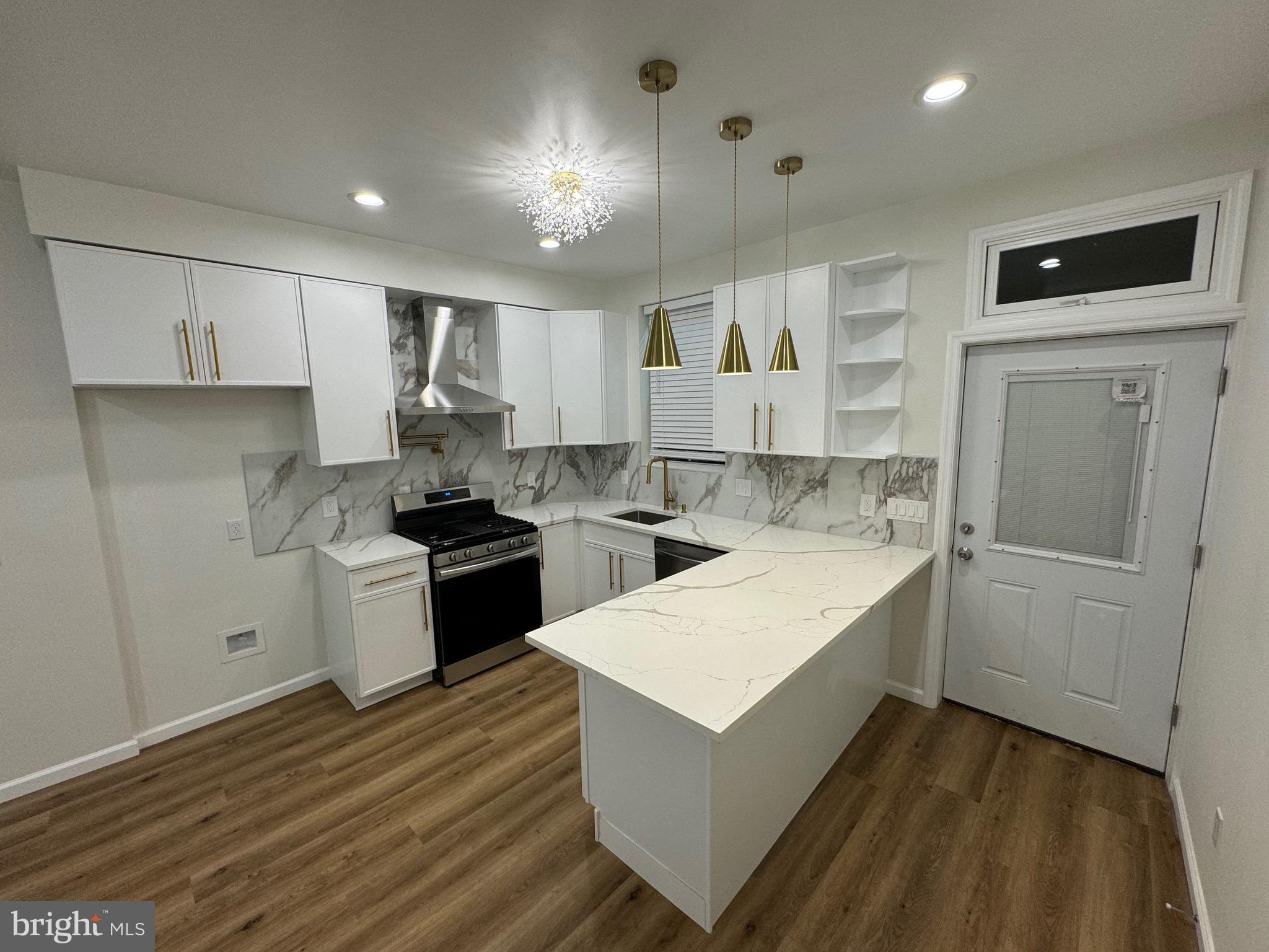 a kitchen with a sink stove and refrigerator