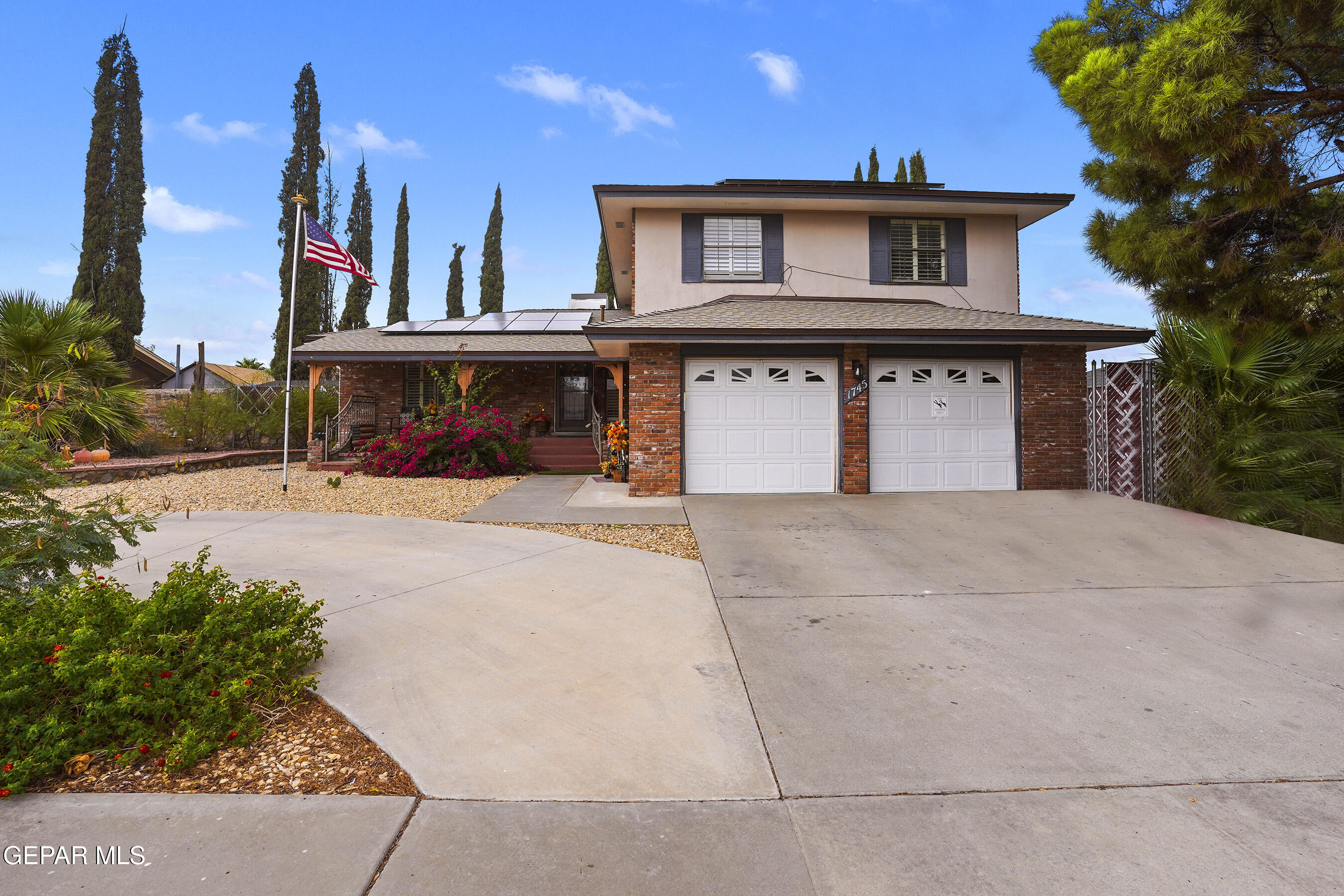 a view of a house with a yard and garage