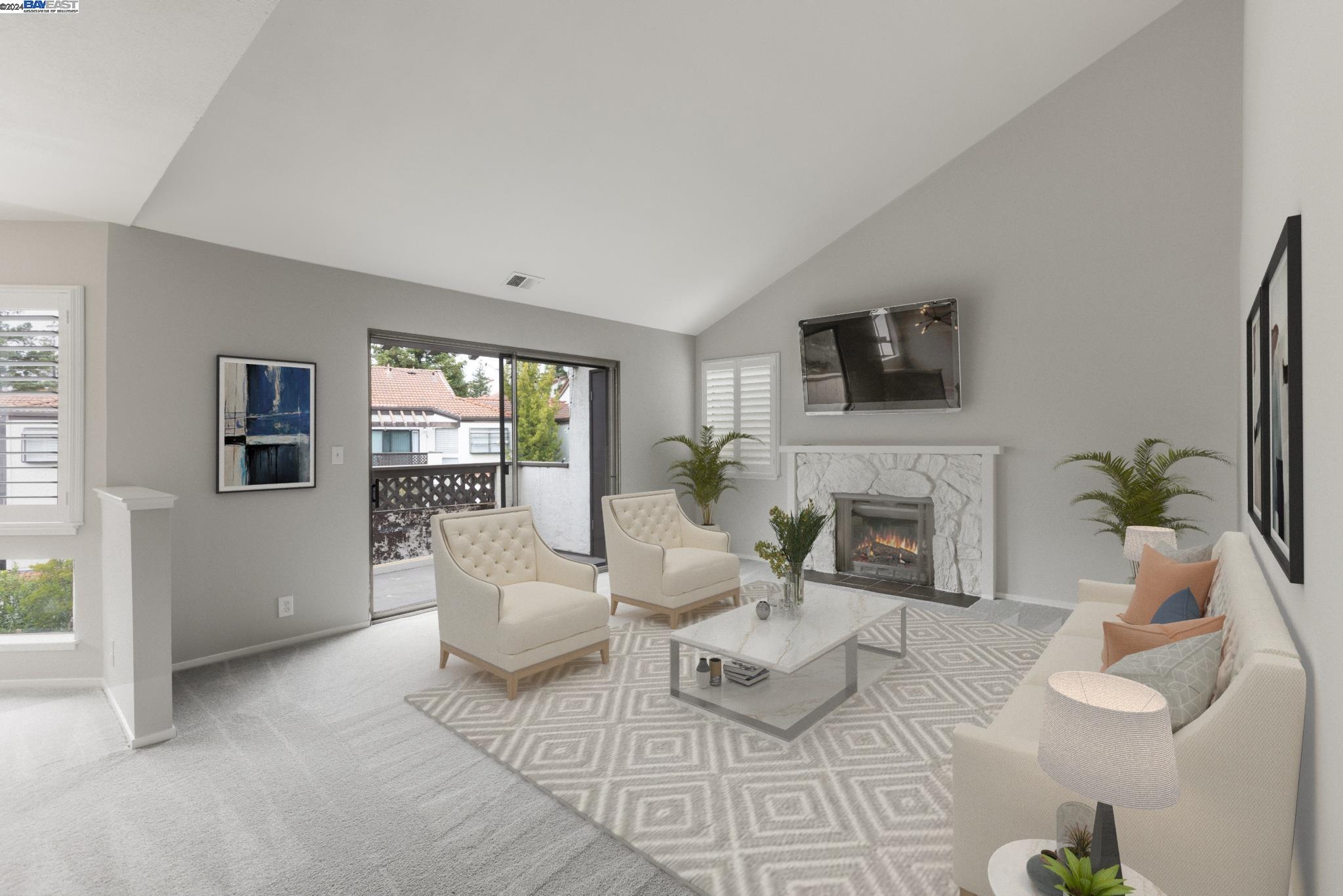 a living room with furniture a fireplace and a flat screen tv