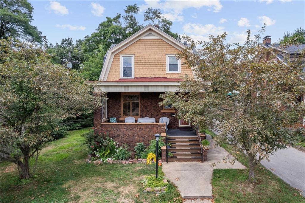 a front view of a house with garden