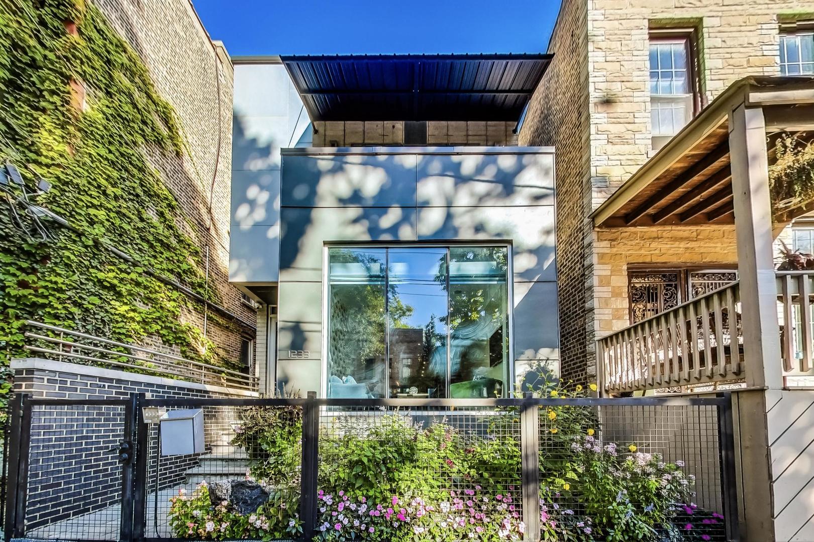 a view of a building with a window and potted plants