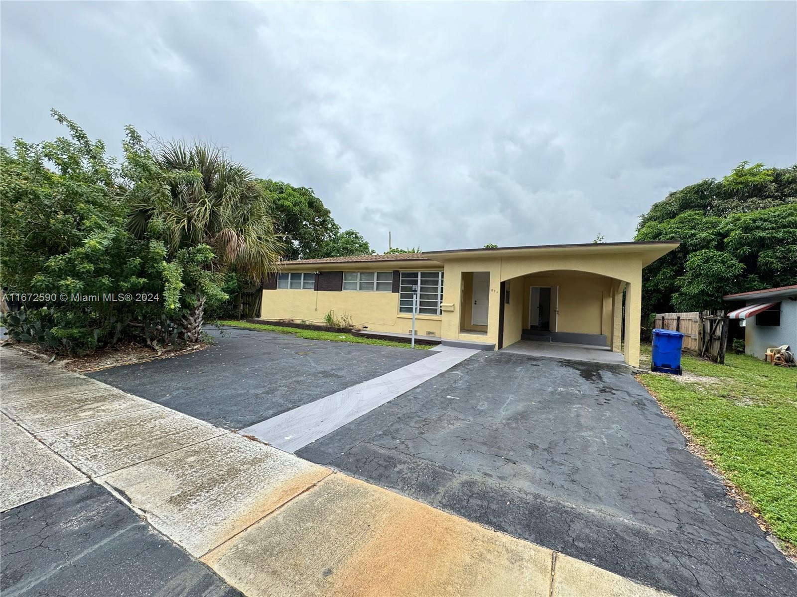 a front view of a house with a yard and a garage