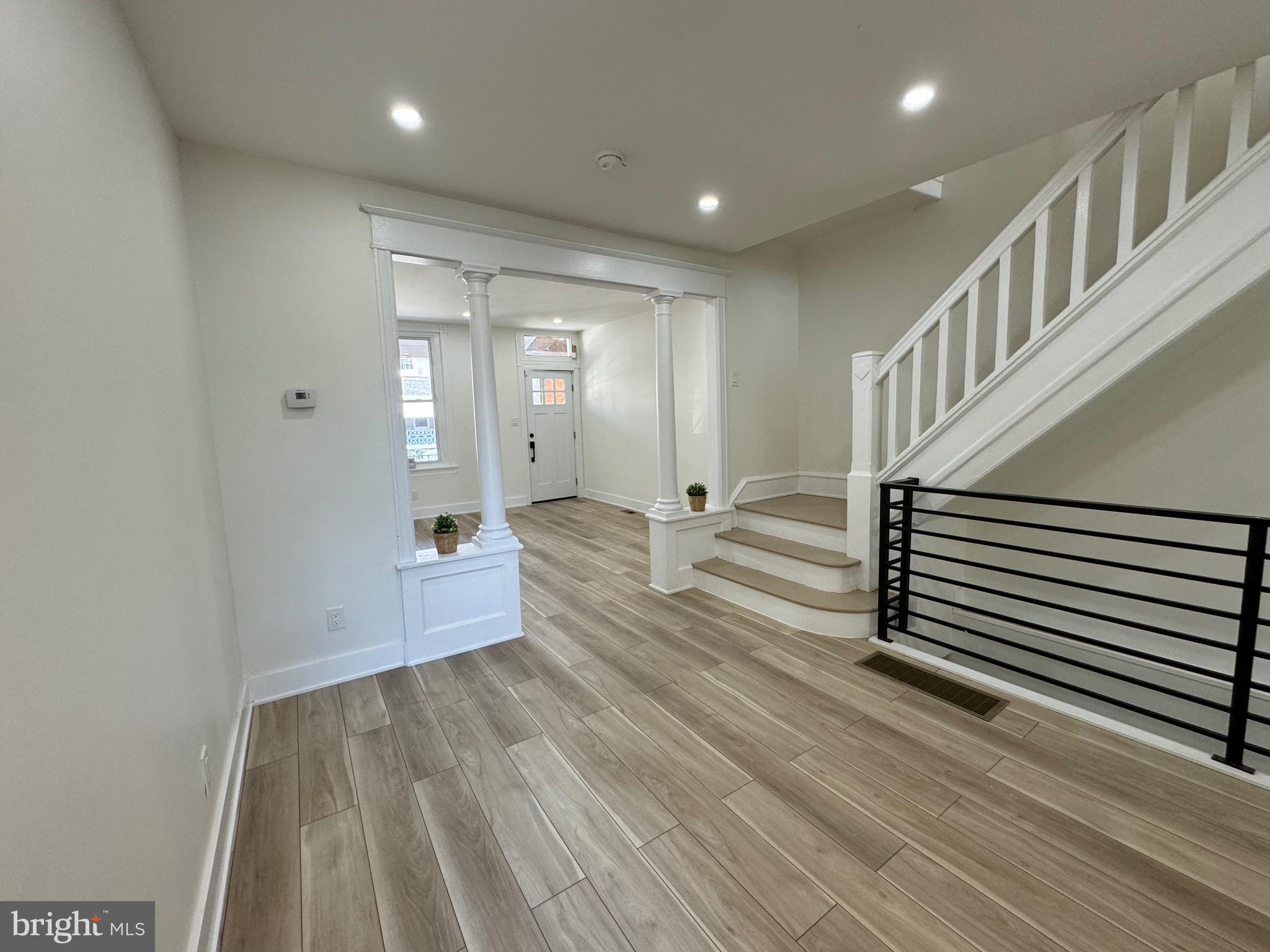 a view of a room with wooden floor