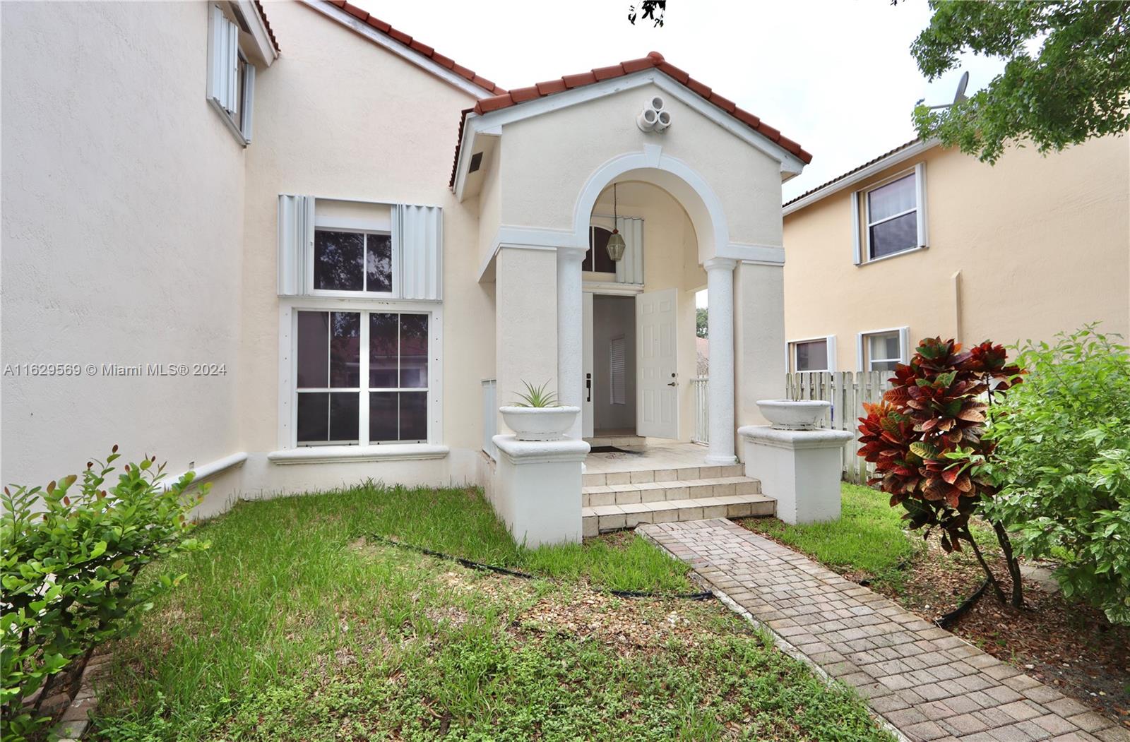 a front view of a house with a garden