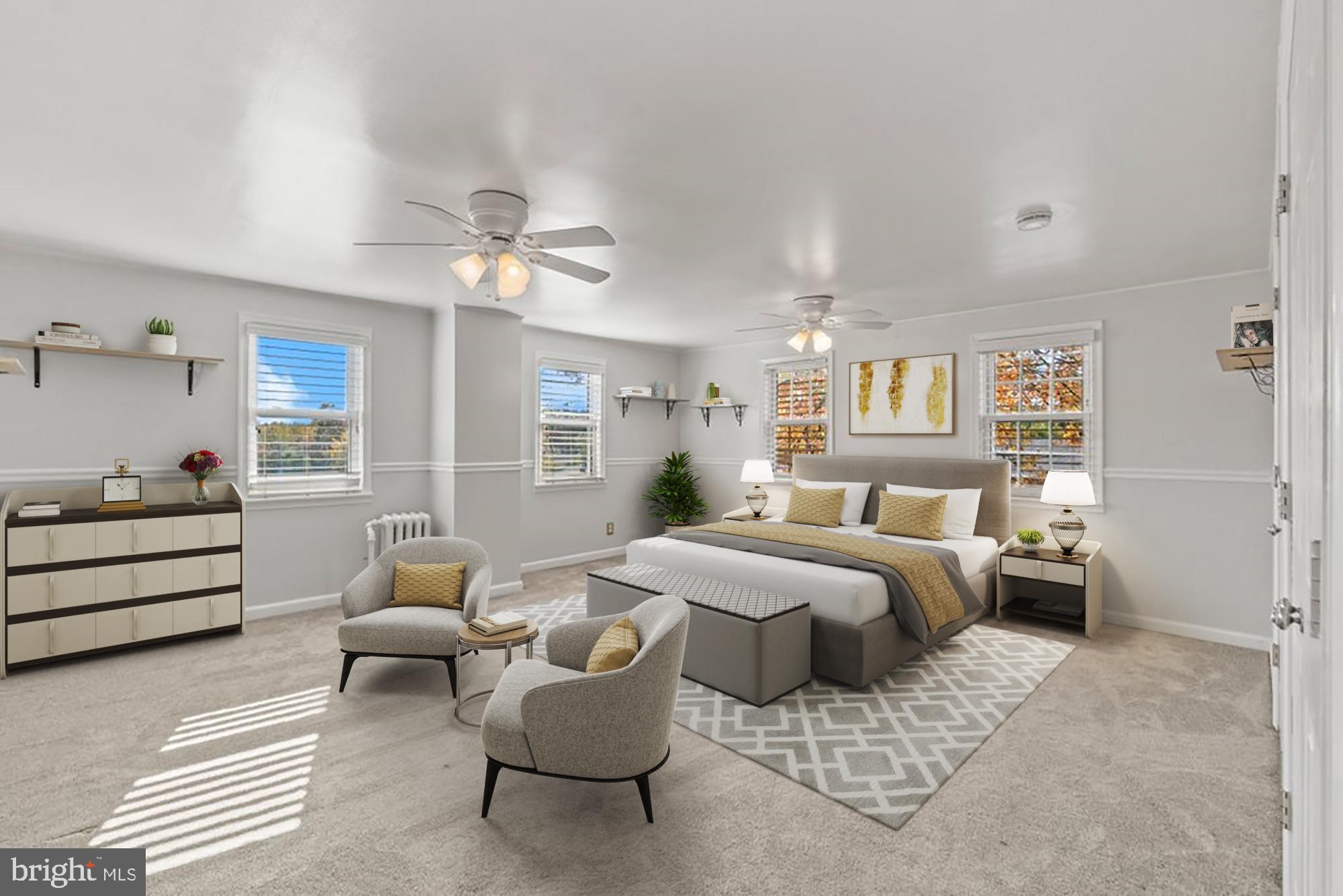 a spacious bedroom with a bed and a chandelier