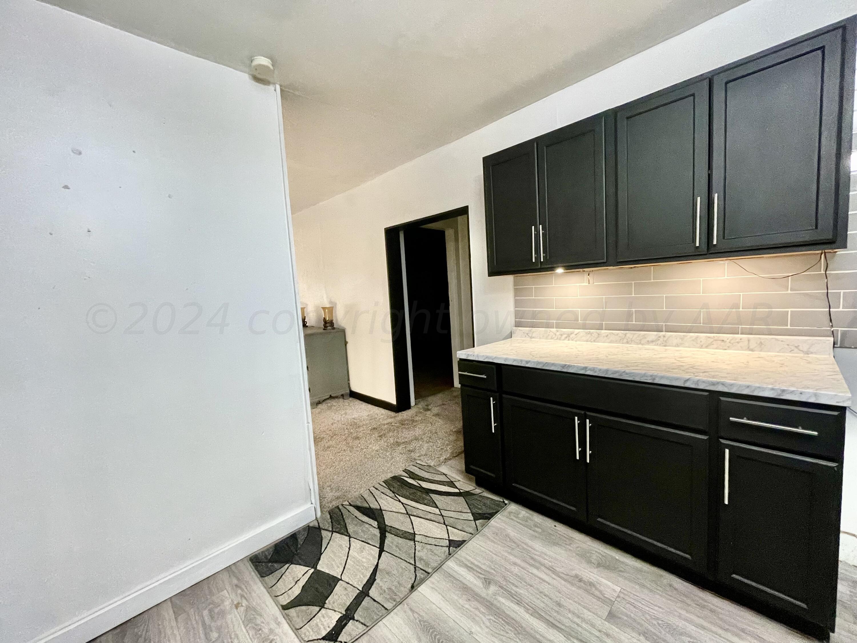 a kitchen with a sink and wooden cabinets