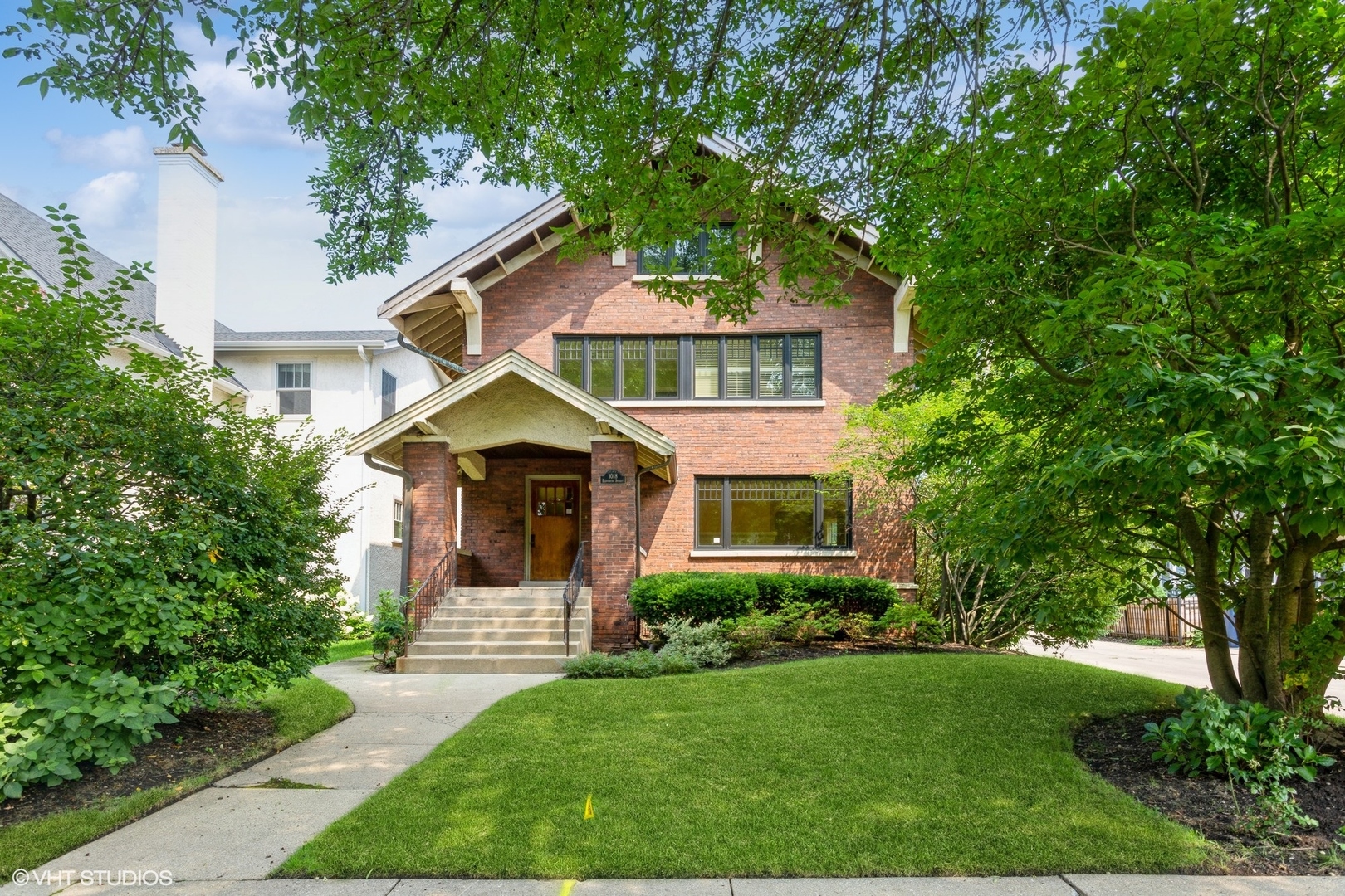 a front view of a house with a garden