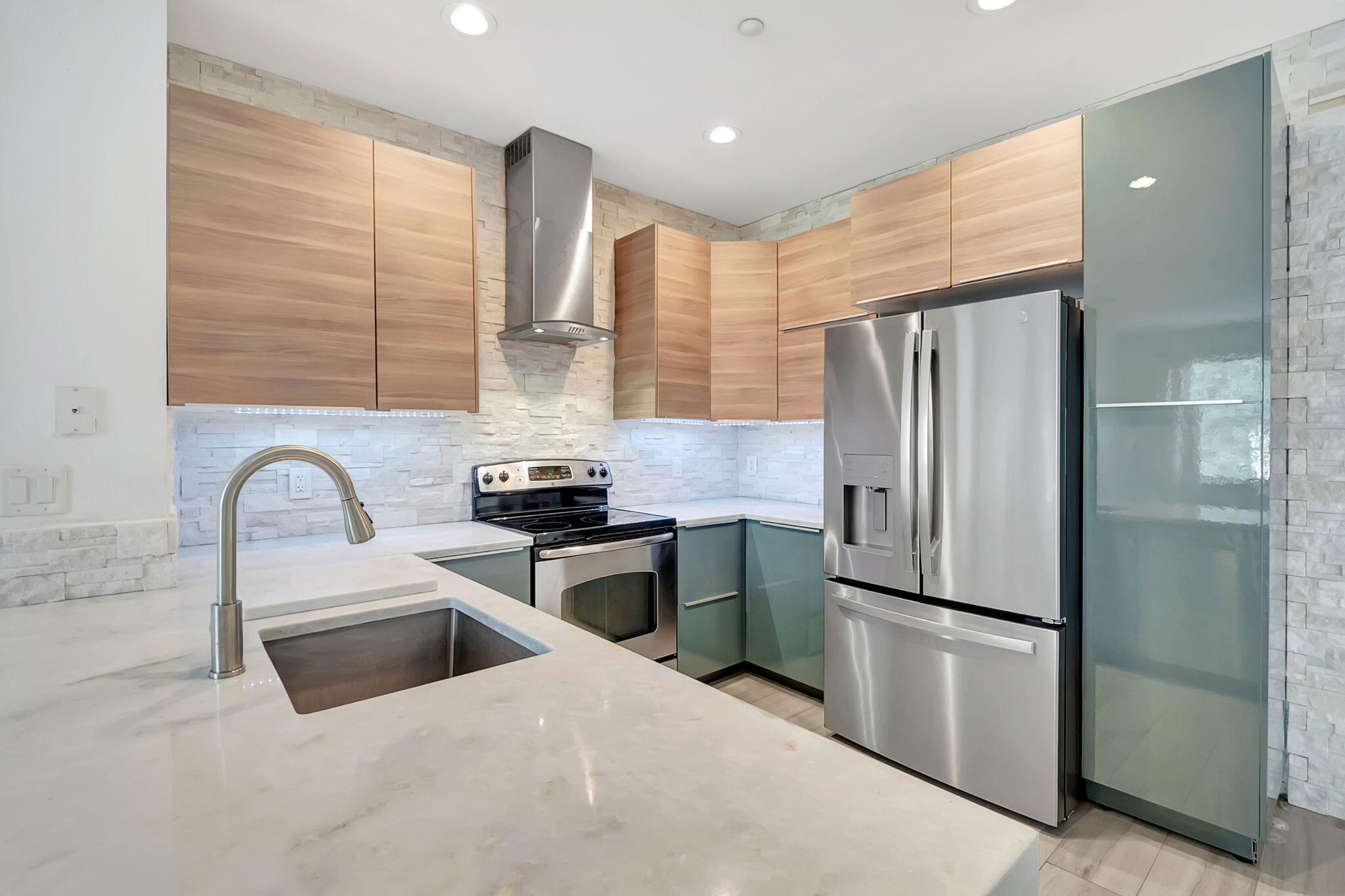 a kitchen with stainless steel appliances a refrigerator sink and cabinets