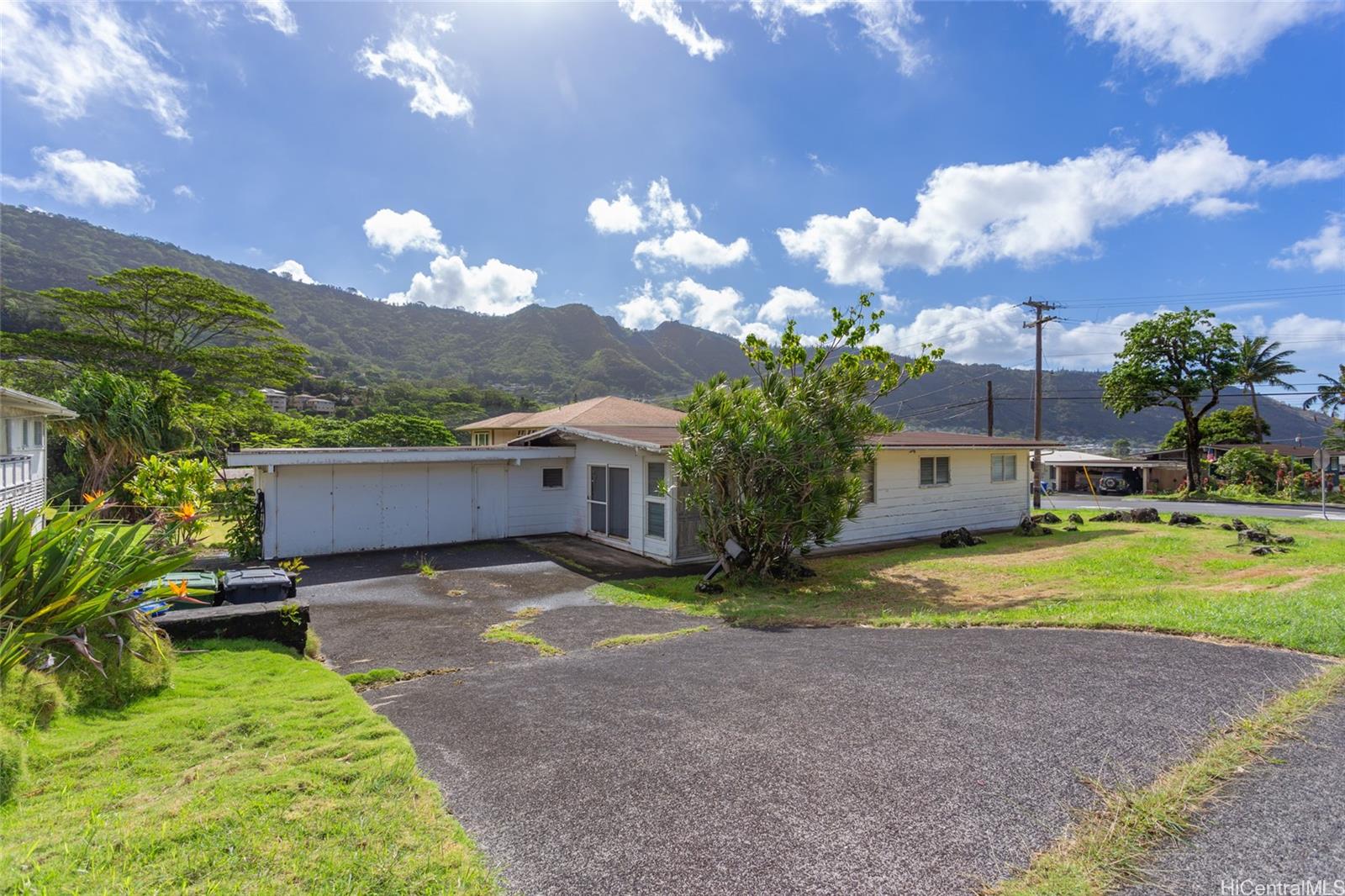 a view of a house with a yard and a patio