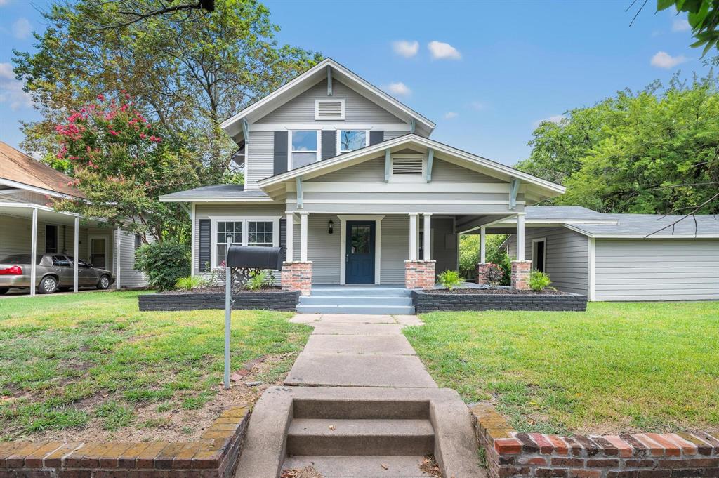 a front view of a house with a yard and porch