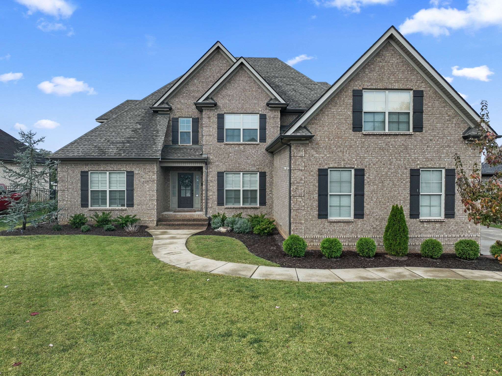 a front view of a house with a yard and porch