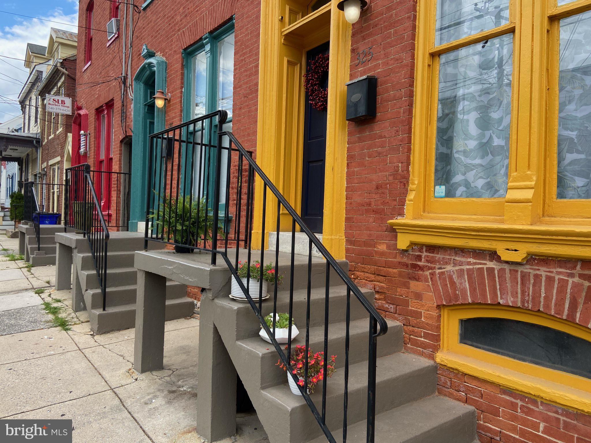 a view of front door of house with stairs