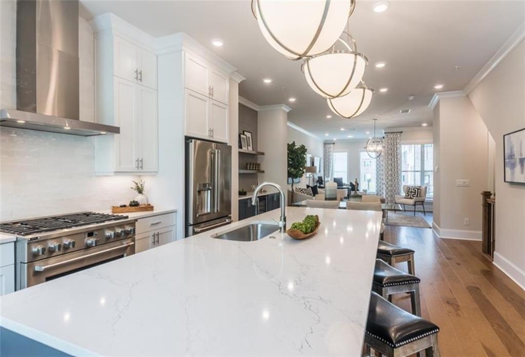 a kitchen with stainless steel appliances a table chairs and a chandelier