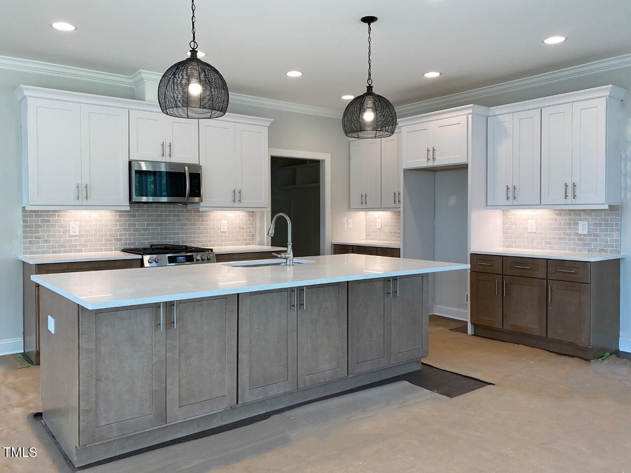 a kitchen with stainless steel appliances a stove a sink and a refrigerator