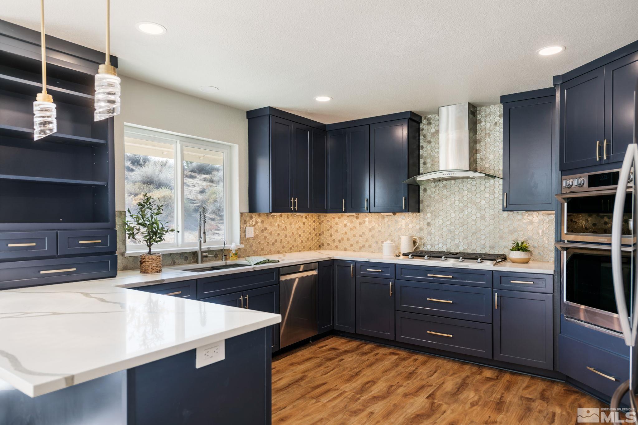 a kitchen with stainless steel appliances granite countertop a sink stove and cabinets