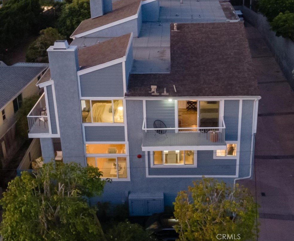 a aerial view of a house with a yard and balcony