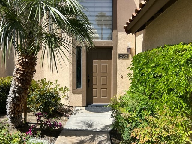 a couple of potted plants in front of door