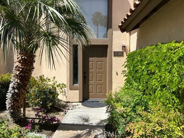 a couple of potted plants in front of door