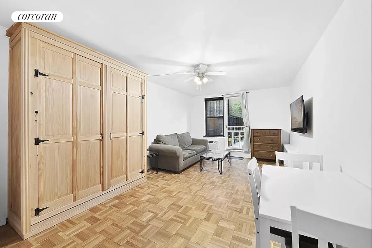 a living room with furniture a flat screen tv and a window