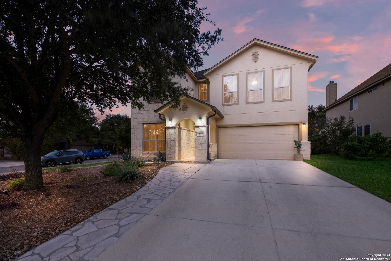 a front view of a house with a yard and garage