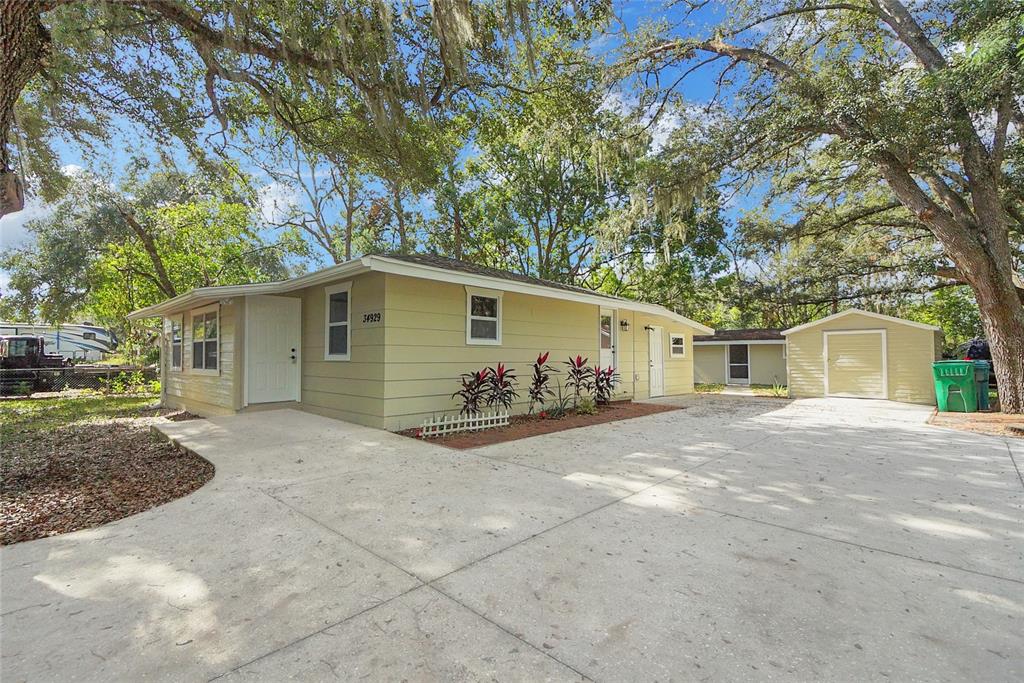 a view of a house with a yard and garage