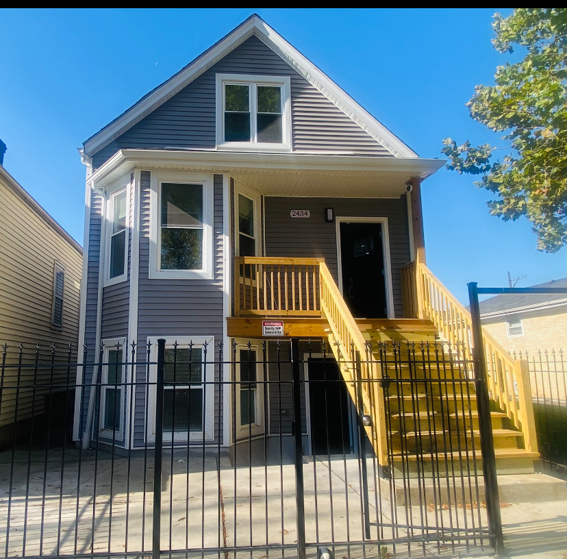 a view of a house with wooden fence