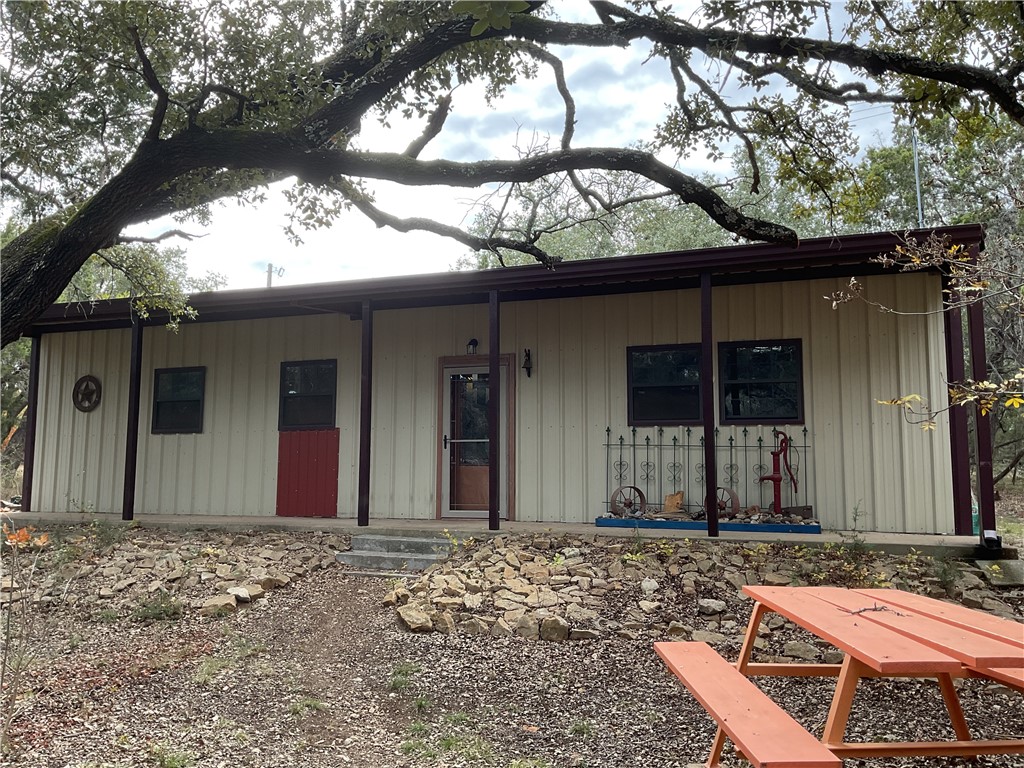 a front view of a house with a tree