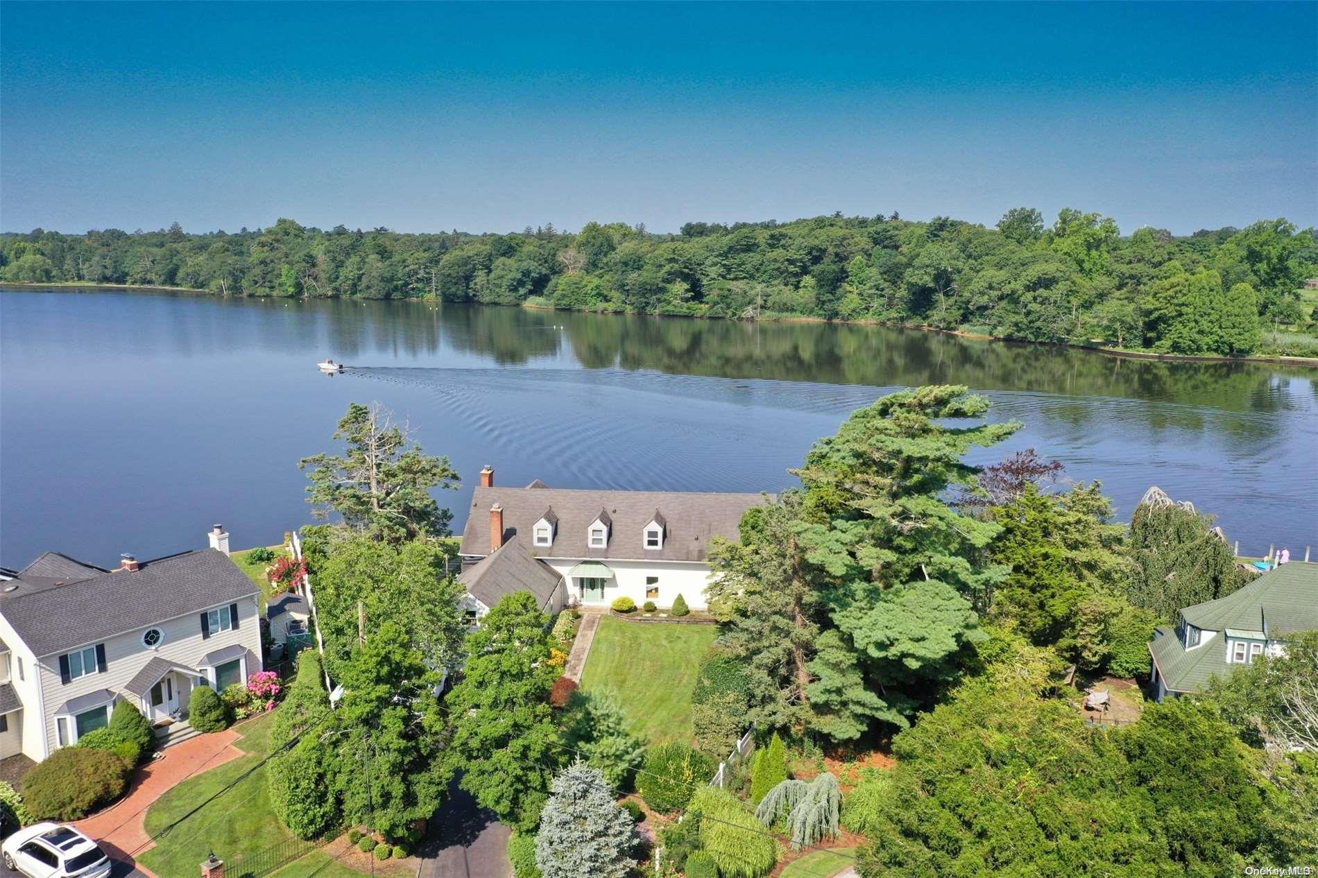 a view of a lake with a house in the background