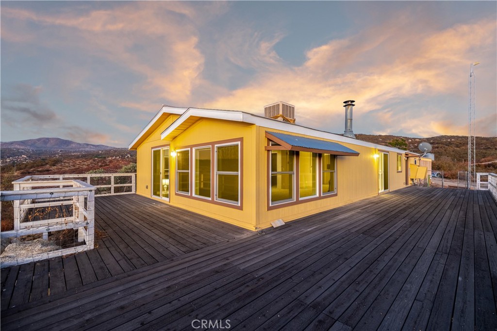 a view of a balcony with wooden floor and city view