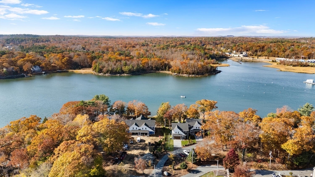 an aerial view of a houses with a lake view