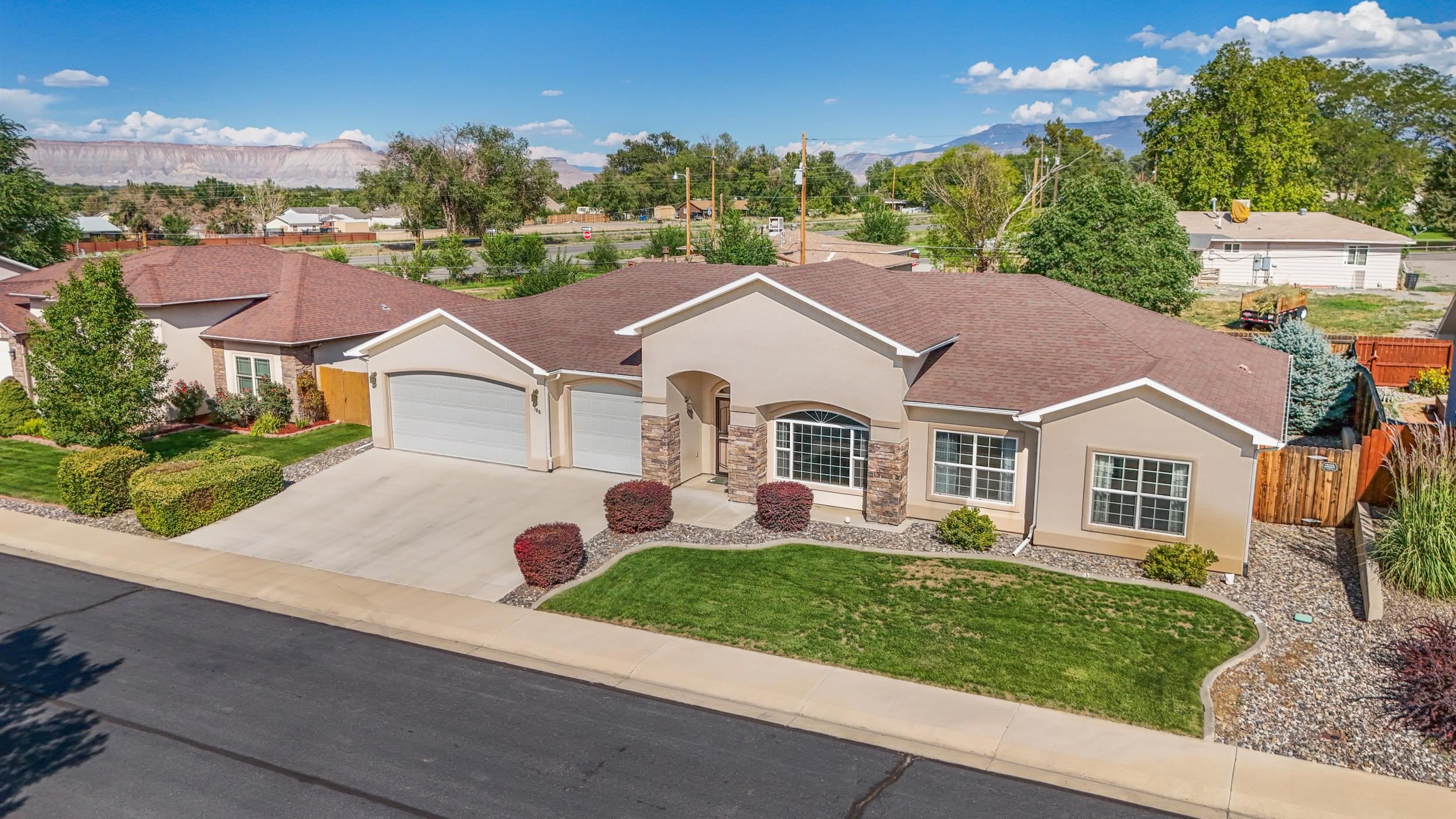 an aerial view of a house with a yard