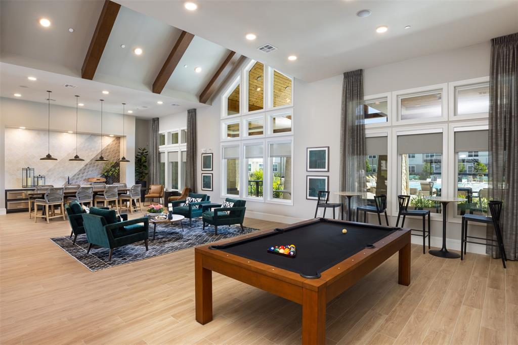 a living room with furniture a wooden floor and a large window