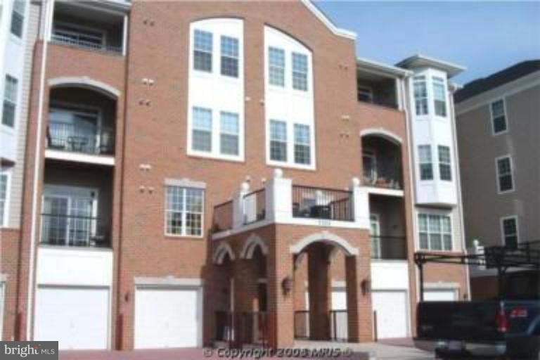 a front view of a residential apartment building with a yard