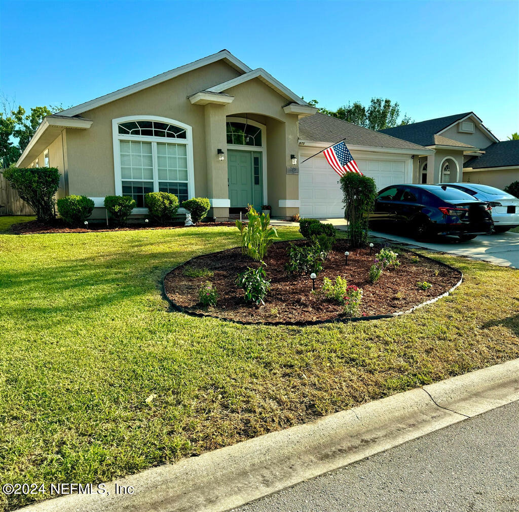 a front view of a house with garden