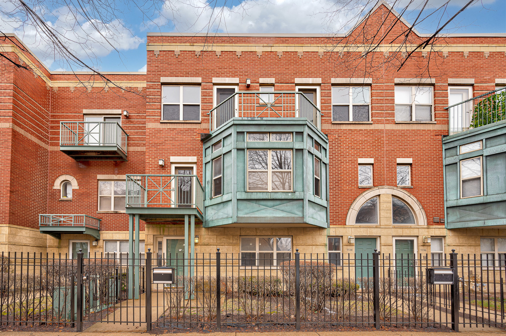 a front view of a residential apartment building with a yard