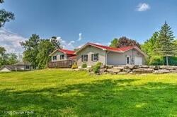 a front view of house with yard and seating area