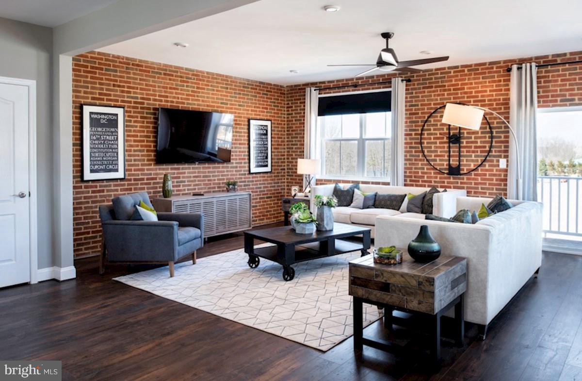 a living room with fireplace furniture and a flat screen tv