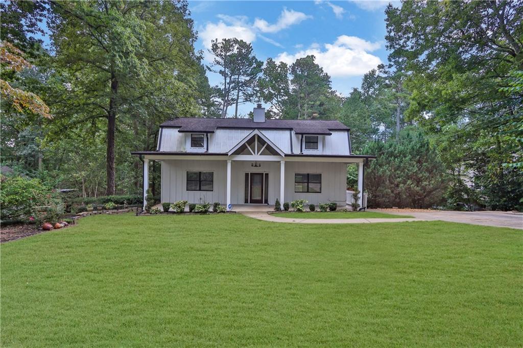 a front view of a house with a garden