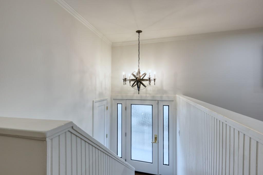 a view of a hallway with a chandelier