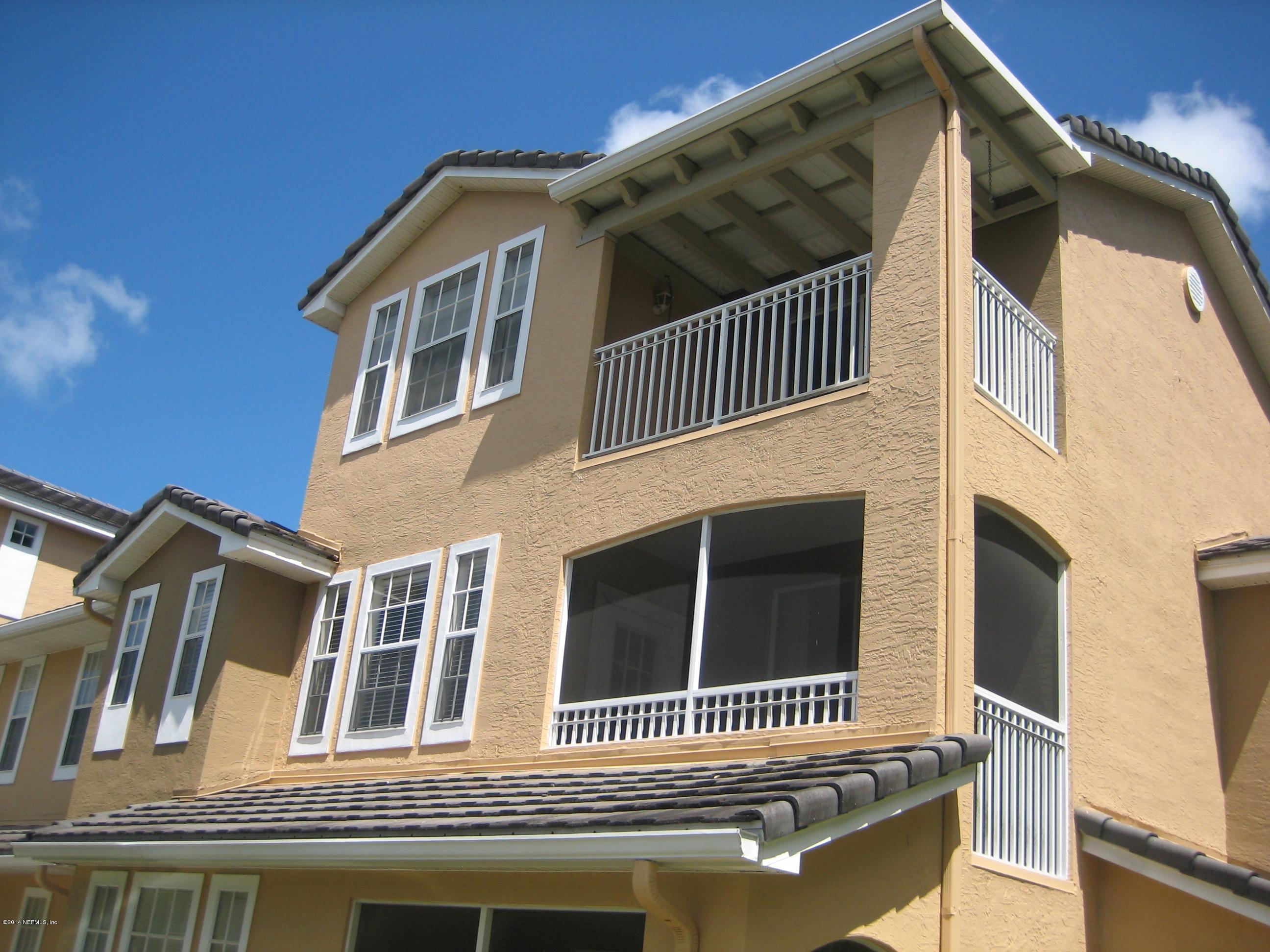 a front view of a house with a fence